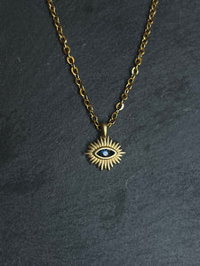 Brass sun and blue eye necklace